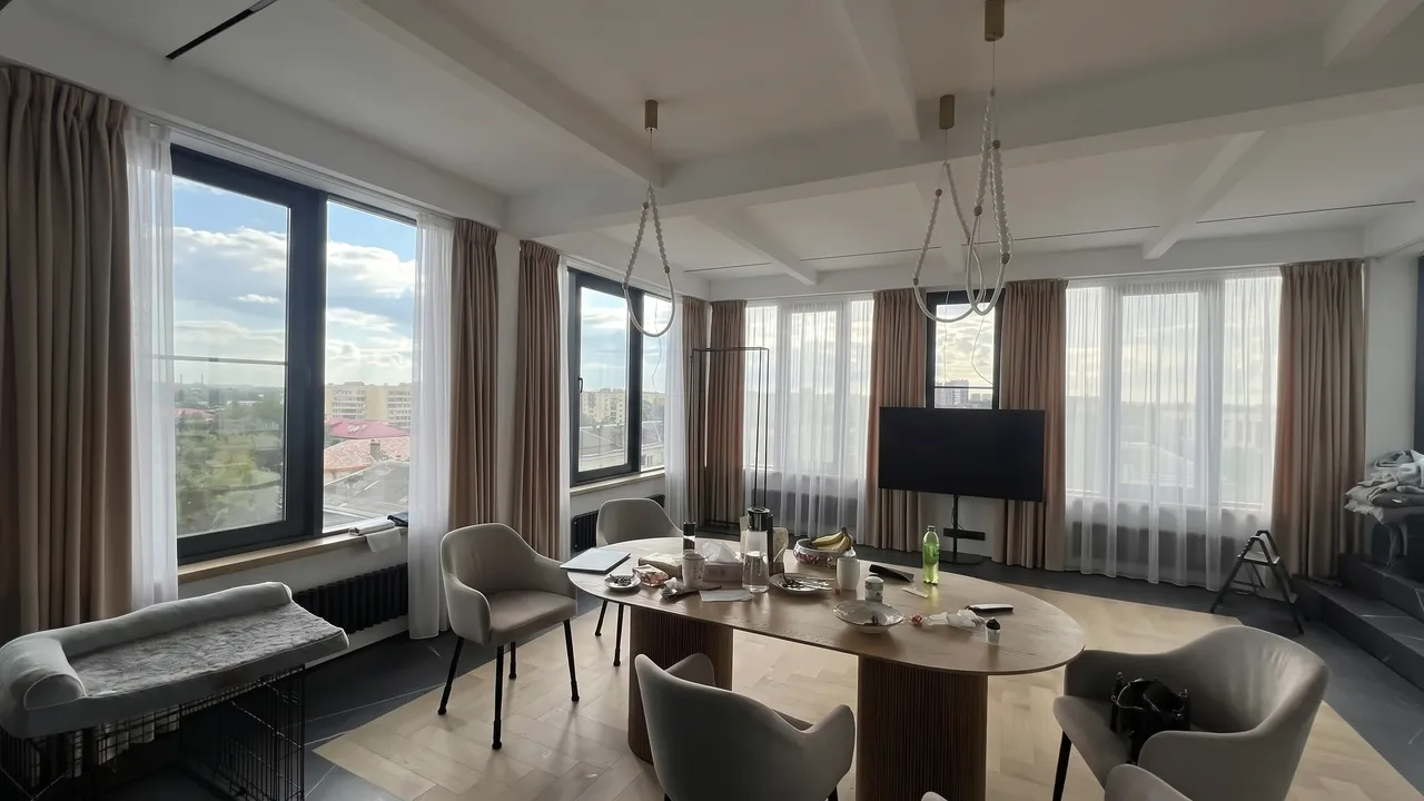 The same room with drapes and white sheer curtains