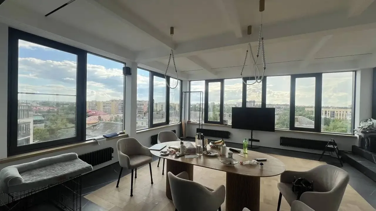 A room with panoramic windows and no curtains